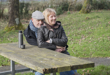 Happy mature couple outdoors laughing 