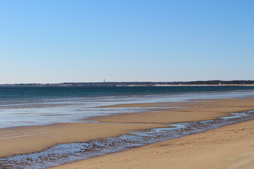 Empty Old Orchard Beach in winter.  Frozen ocean.