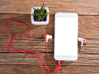 smart phone and ears plug on wooden background