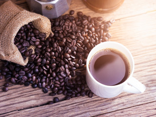 black roasted coffee beans on aged wood