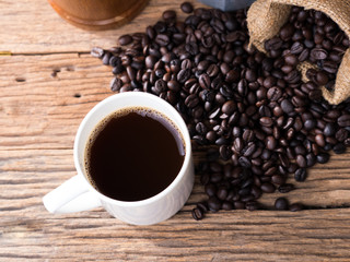 black roasted coffee beans on aged wood