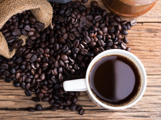 black roasted coffee beans on aged wood