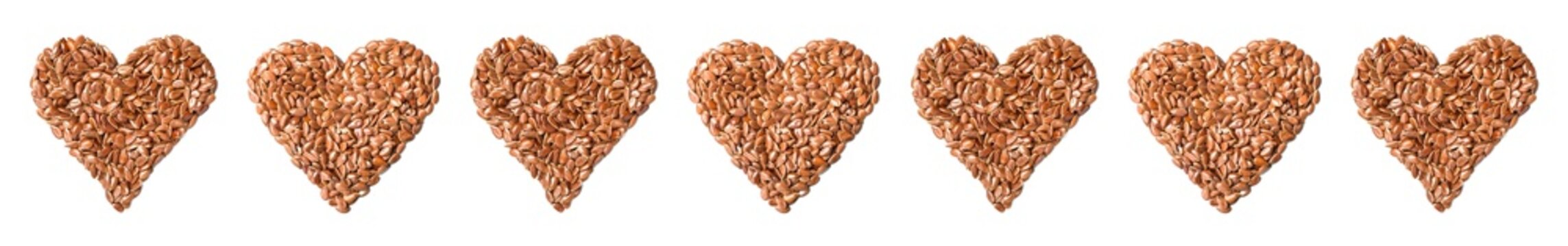 heart shape of flax seeds on white, top view