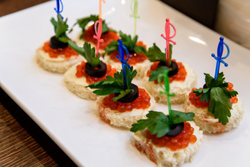 Canape with red caviar.