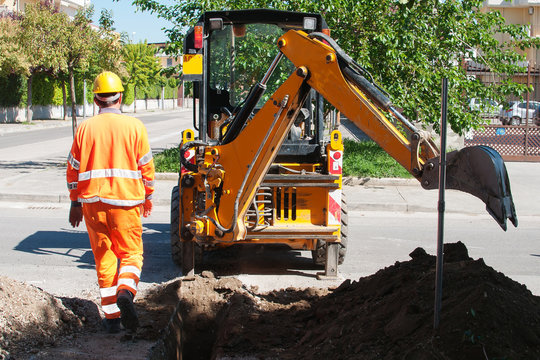 .Repairing the damaged asphalt in a city street.