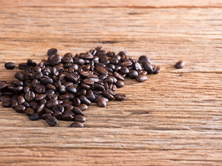 black roasted coffee beans on aged wood