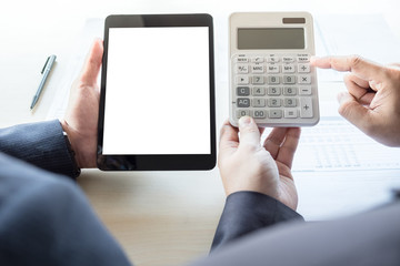 Businessman analysis on calculator, new plan financial graph data with business colleagues using digital tablet for estimation at the office, invesment concept