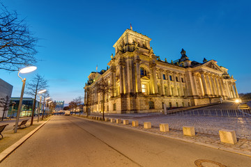 Fototapeta premium The famous german Reichstag in Berlin illuminated before sunrise