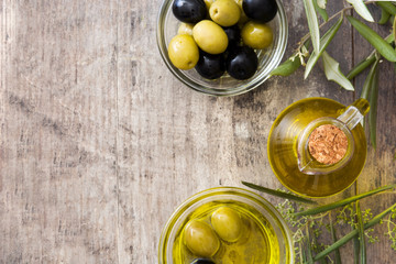 Virgin olive oil in a crystal bottle on wooden background. Top view
