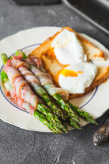 Baked green asparagus wrapped with bacon