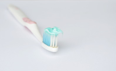 toothpaste put on toothbrush in white background