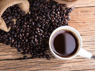 black roasted coffee beans on aged wood