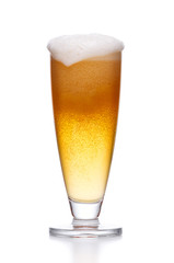 Misted glass of light beer on white.