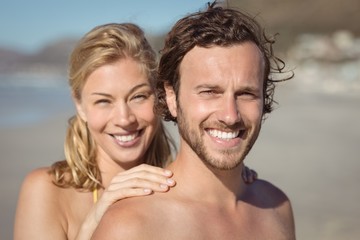 Fototapeta premium Portrait of smiling couple at beach