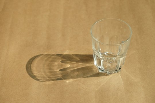 Glass of water on background