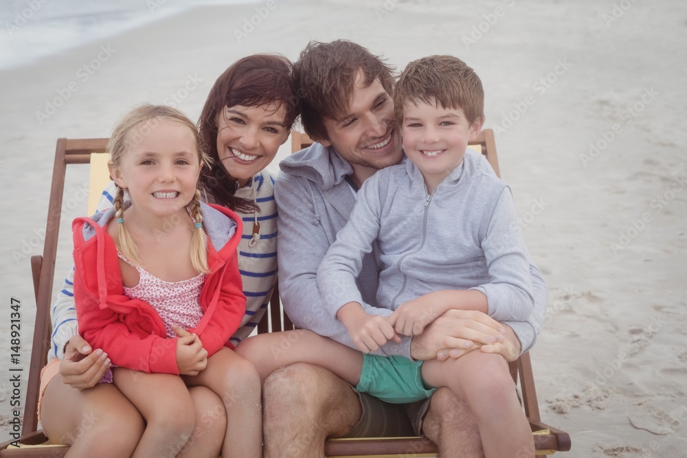 Wall mural happy family resting on lounge chairs