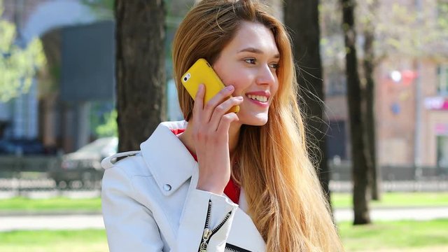 Calling by Phone. Happy  blonde model talking on cell phone