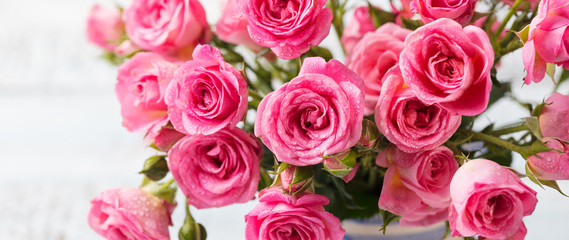 Rose flowers in vase. Copy space. Top view