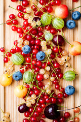 Fresh berries on wooden cutting board. Top view