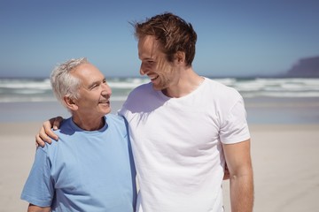 Happy family standing at beach