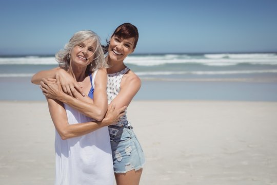 Portrait of happy woman with her mother standing at beach