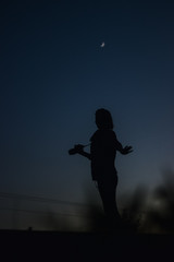 Fototapeta na wymiar blue girl with camera silhouette in the street night