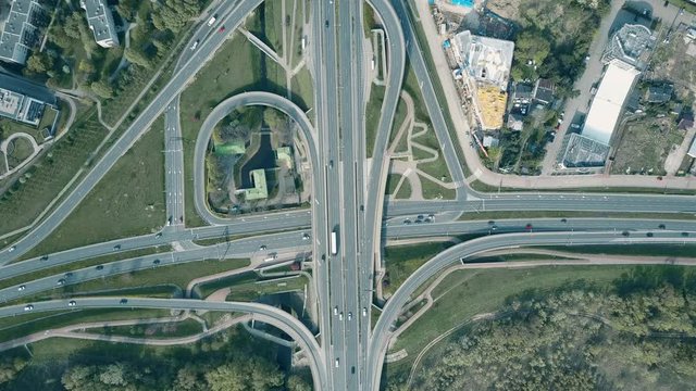 Aerial shot of road junction in an industrial area, top down view. 4K video