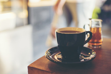 black coffee on the table in cafe, vintage filter image
