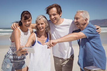 Cheerful family looking at mobile phone