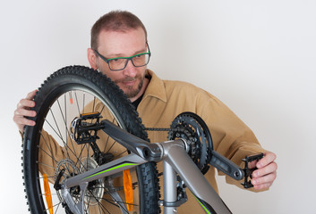 Bearded caucasian man repairing the mtb bicycle