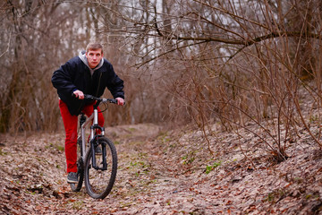 Fototapeta na wymiar cyclist riding a mountain bike along the forest road