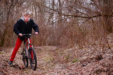 cyclist riding a mountain bike along the forest road