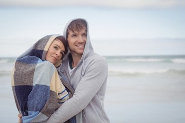 Thoughtful young couple embracing during winter