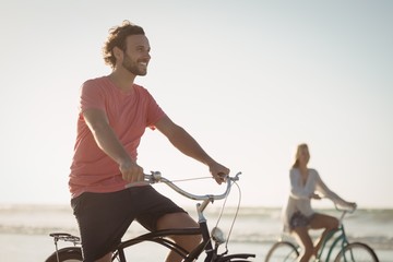 Happy riding bicycle at beach