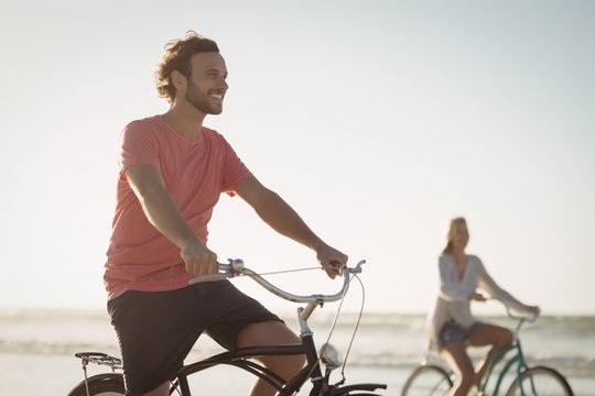 Happy Riding Bicycle At Beach