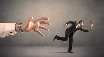 Businessman running from hand