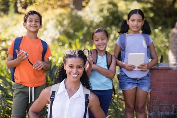 Portrait of happy teacher and students