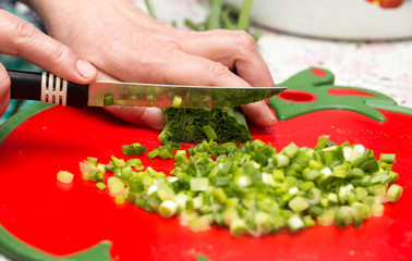 Cook cuts green onions with a knife