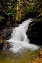 Fototapeta na wymiar Beautiful Thai natural waterfall in a rocky gorge.