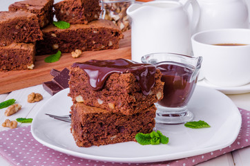 Chocolate cake brownie with walnuts and chocolate sauce