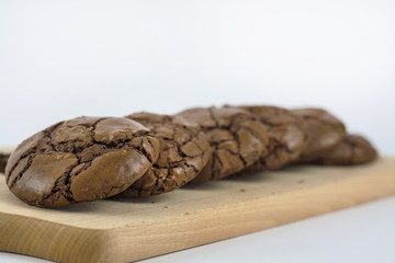 Black Brownie Cookies on wooden chopping board