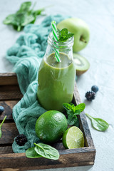 Green smoothie wtih spinach and lime, healthy detox vitamin diet or vegan food concept