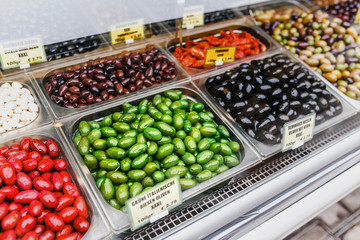 Bowls of various olives for sale at a open street market with price tags