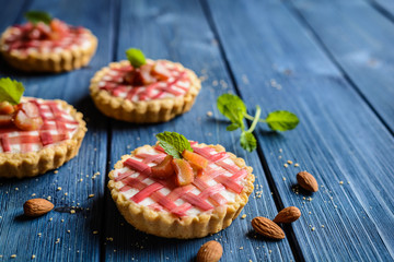 Almond tartlets filled with curd and topped with rhubarb