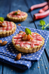Almond tartlets filled with curd and topped with rhubarb
