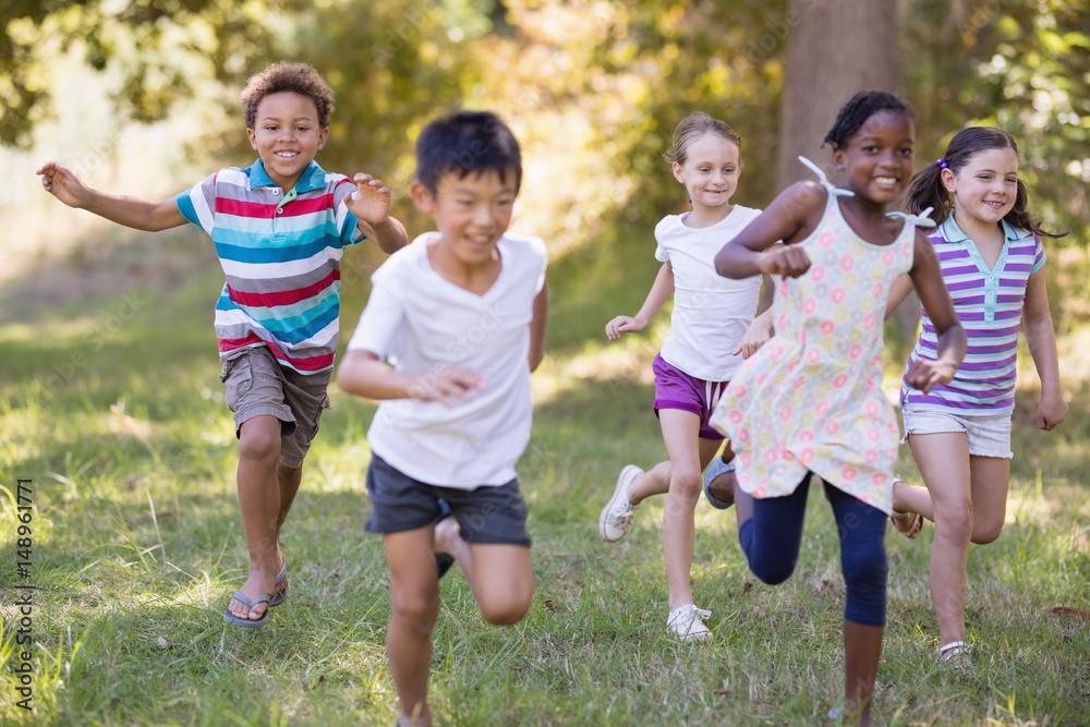 Wall mural happy friends running at campsite