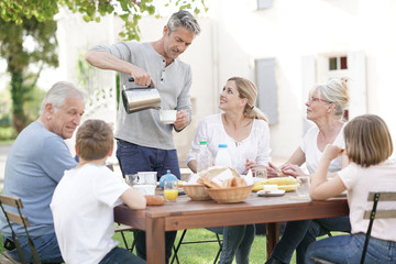 Family having breakfast together in holiday home