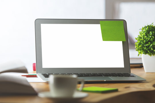 Blank white laptop with green sticker