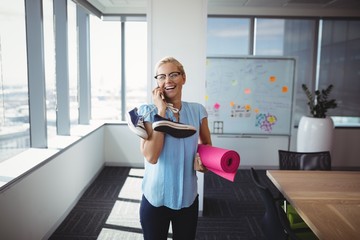 Smiling executive talking on mobile phone 