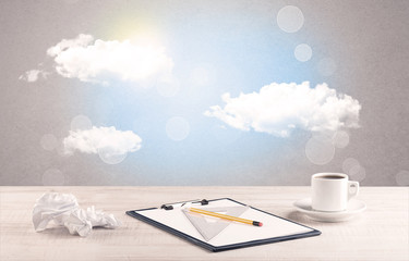 Bright sky with clouds and office desk
